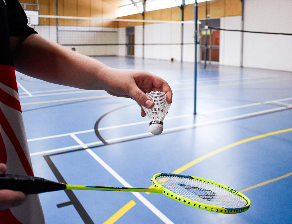 Education News - Student playing badminton